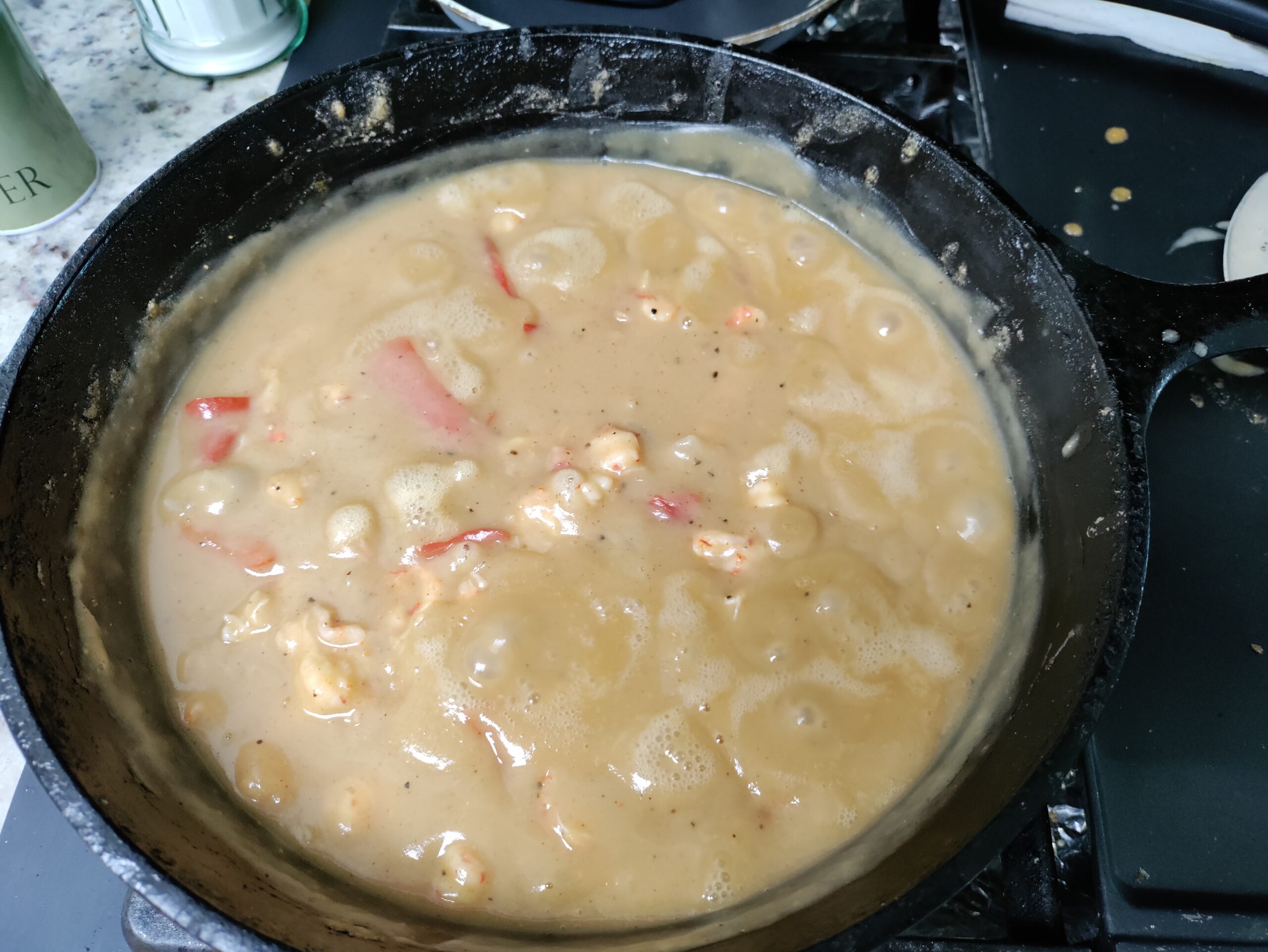 A delicious iron pot of simmering crawfish etouffee.